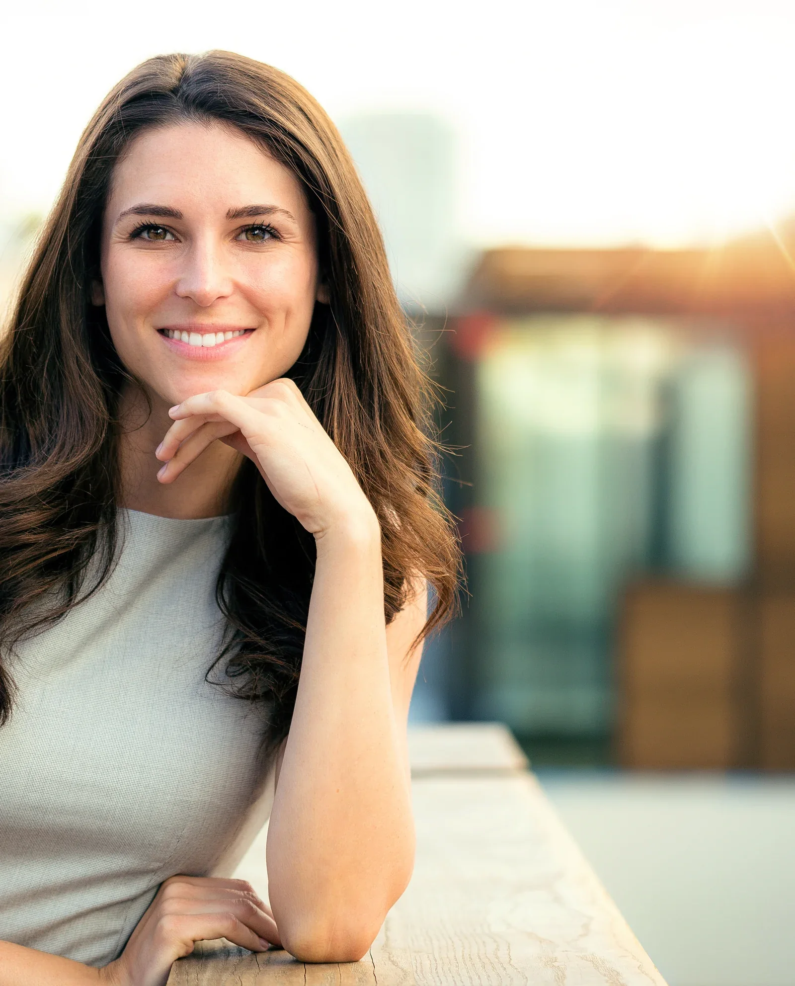 A smiling woman in soft natural light.