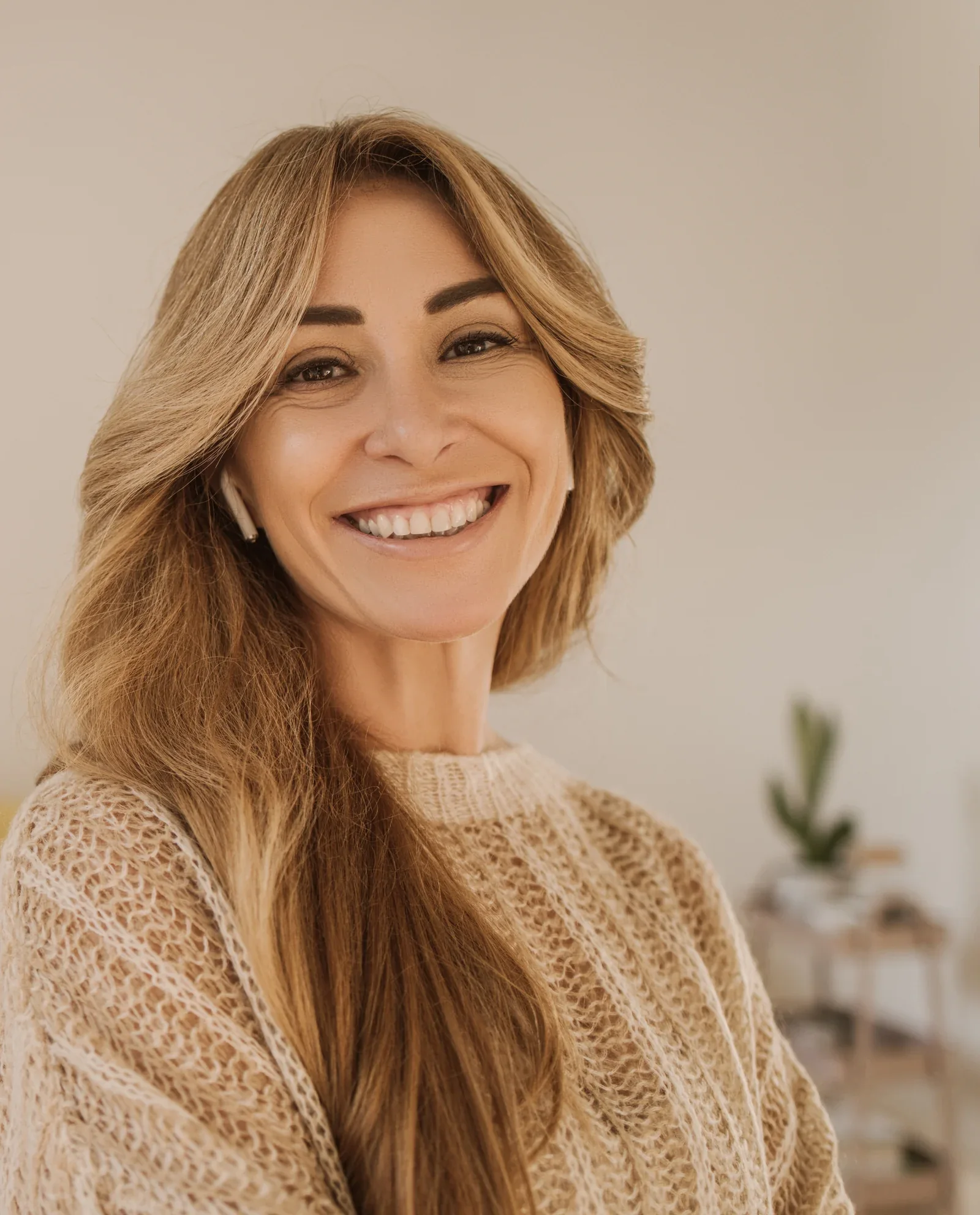 A smiling woman in soft natural light.