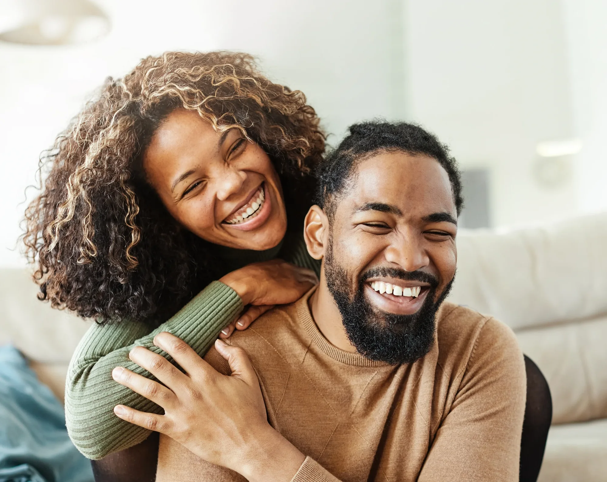 A smiling couple relaxing together at home.
